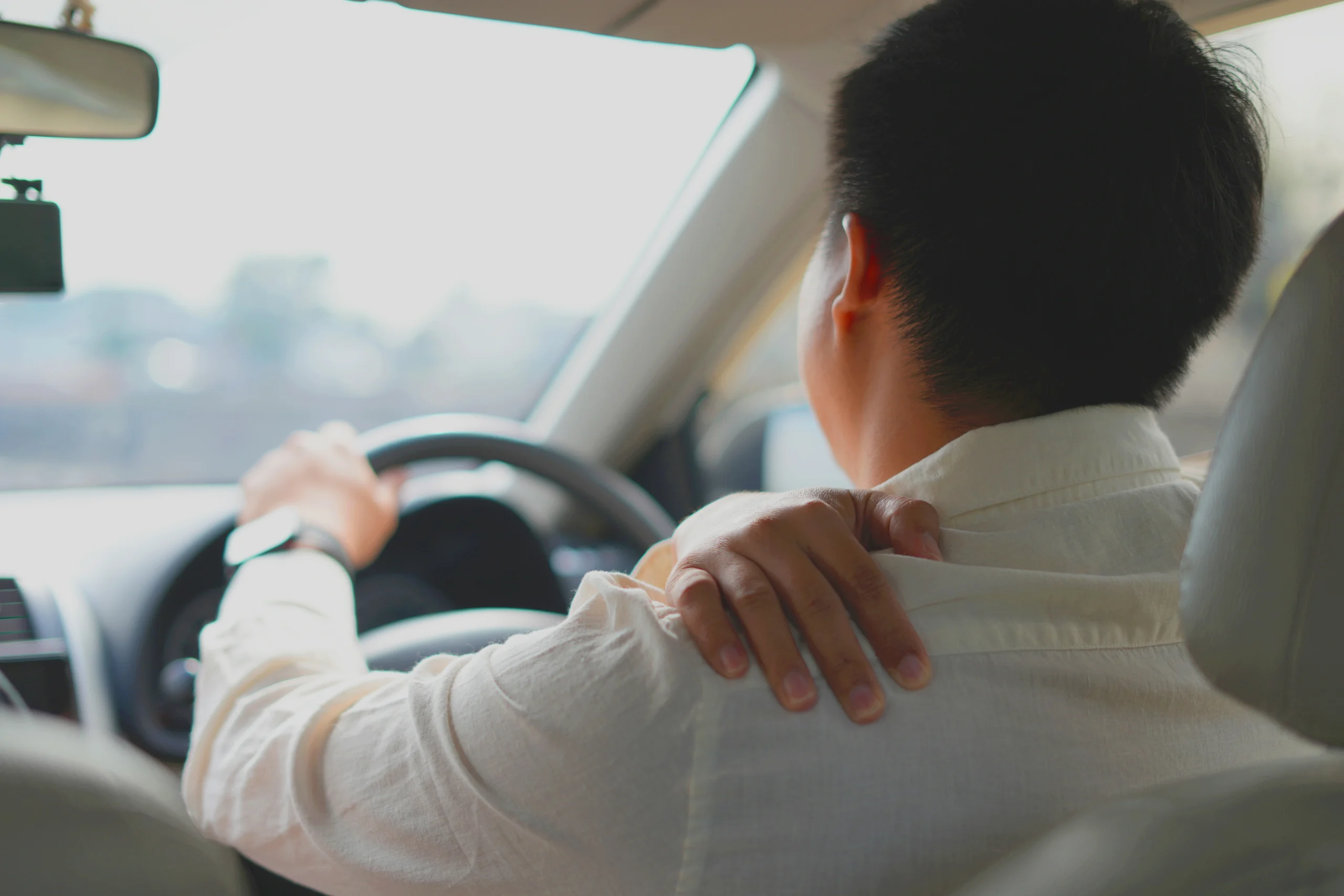 Patient driving their car after receiving reverse shoulder replacement treatment.