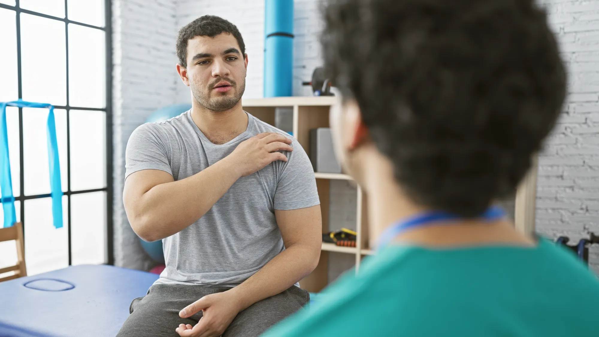a patient and doctor going over AC Joint Separation causes, symptoms, and treatments.