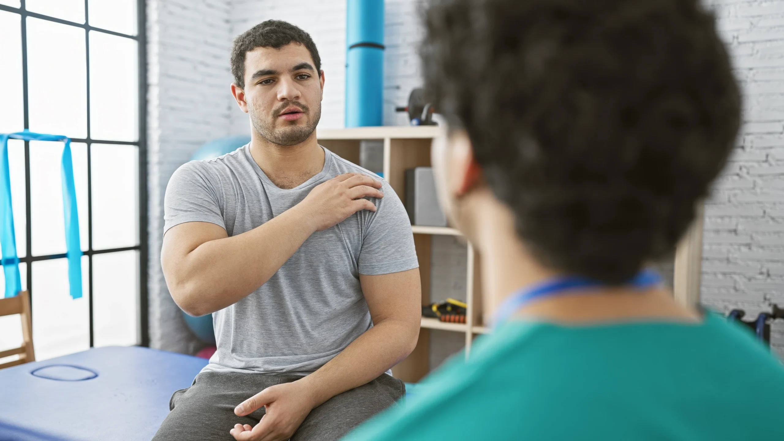 a patient and doctor going over AC Joint Separation causes, symptoms, and treatments.