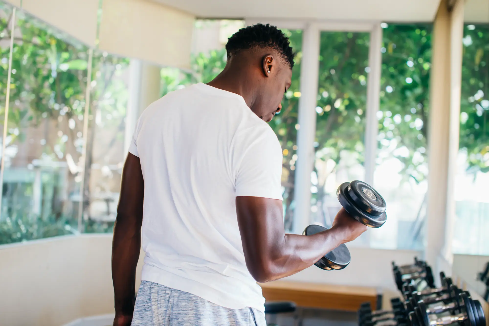 A man working out but struggling with elbow pain, wondering what is cubital tunnel syndrome