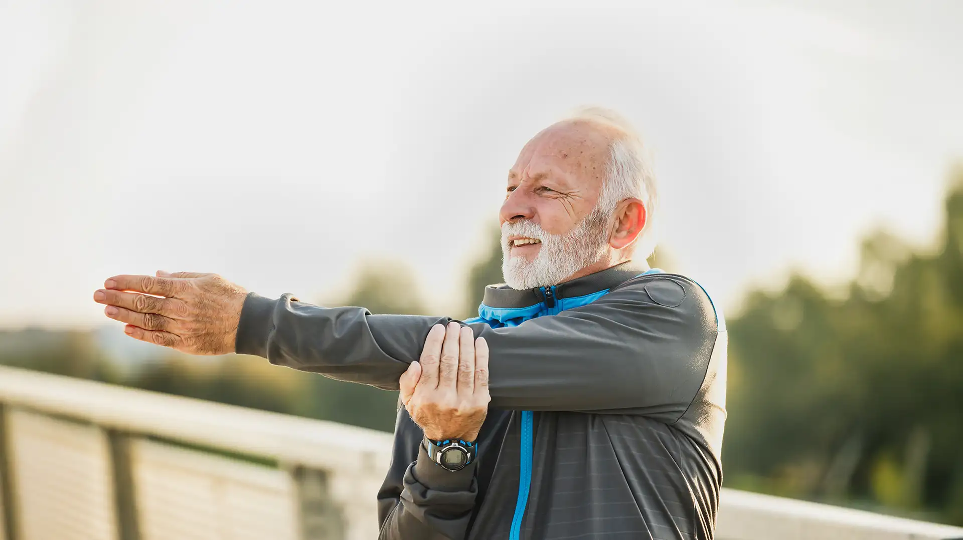 Older adult performing a shoulder stretching exercise as part of physical therapy