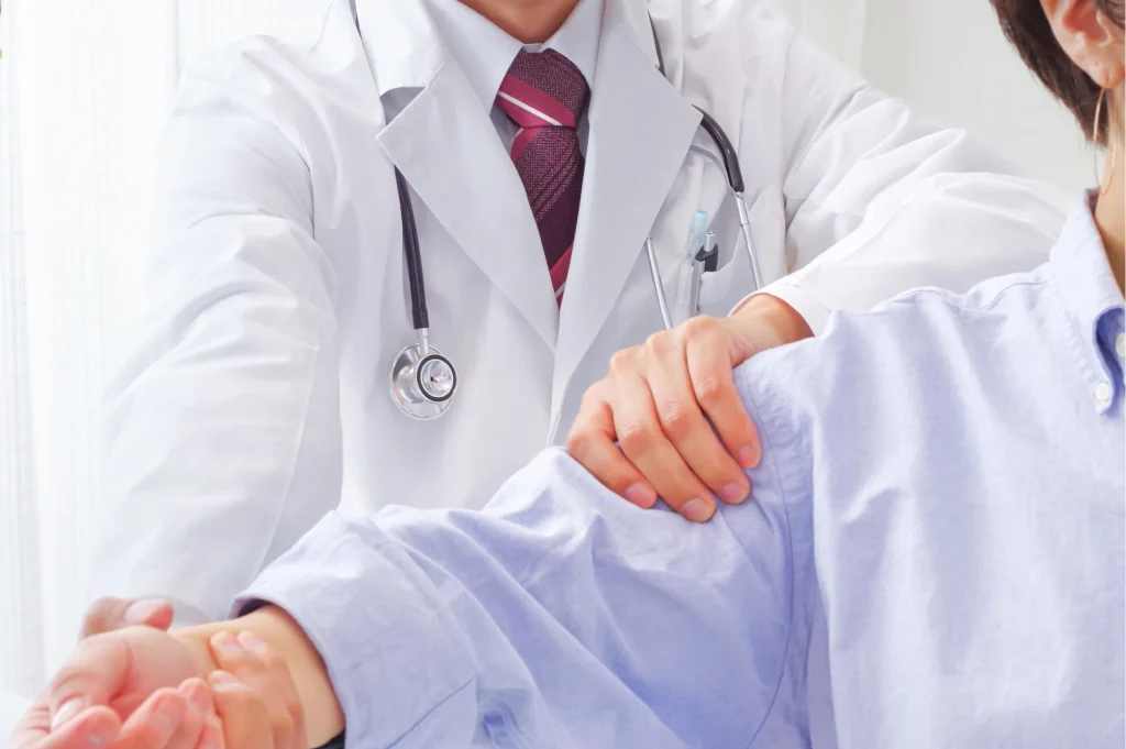 Doctor checking out a patient with a frozen shoulder