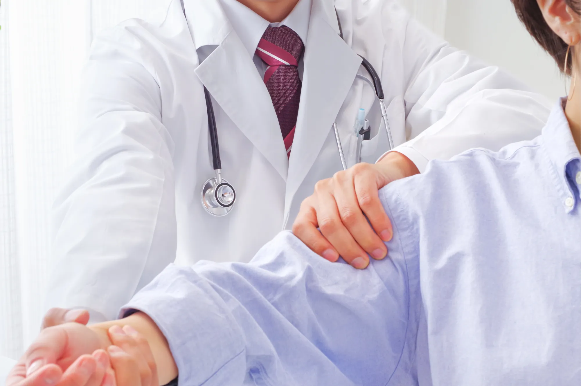 Doctor checking out a patient with a frozen shoulder