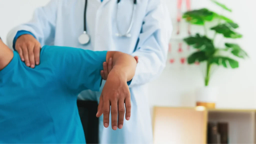 Doctor supporting a patient's arm while examining their shoulder range of motion